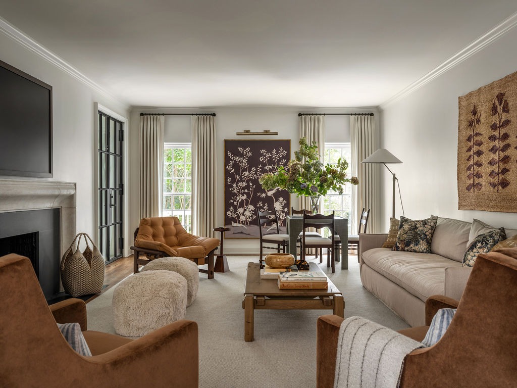 Living room with cognac leather armchairs and framed chinoiserie panel
